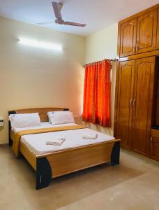 a bedroom with two beds and a window at Ponni Delta Nature Stay by the River in Fort