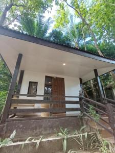 a view of the front of a house with a wooden door at Tay Deling's Place in El Nido