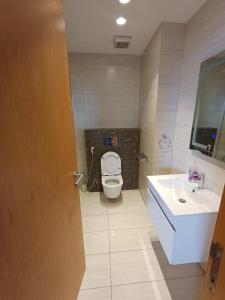 a bathroom with a toilet and a sink at Studio at Damak Jordan in Amman