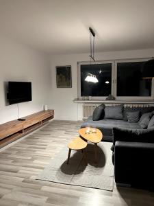 a living room with a couch and a table at Somewhere2Stay Apartment in Oberhausen City in Oberhausen