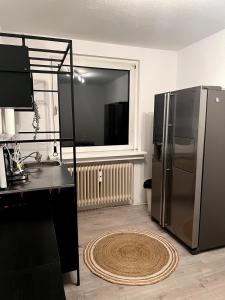 a kitchen with a stainless steel refrigerator and a window at Somewhere2Stay Apartment in Oberhausen City in Oberhausen
