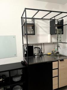 a kitchen with a black counter and a sink at Somewhere2Stay Apartment in Oberhausen City in Oberhausen