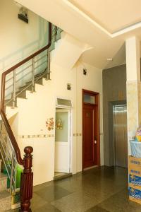 a hallway with a staircase in a house at Tấn Đạt Hotel Quy Nhơn in Quy Nhon