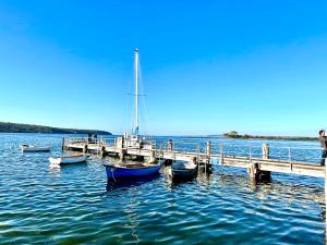 a sailboat is docked at a dock on the water at Lazy Shanty in American River