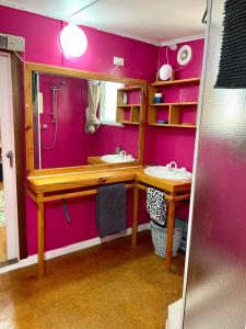a purple bathroom with two sinks and a shower at The Shanty in American River