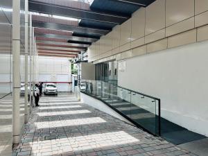 a hallway with escalators in a building with a car at ZIBE Luxe Kakinada by GRT Hotels in Kākināda