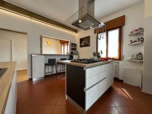 a kitchen with a stove and a counter top at Venezia-Mestre Train Station Relax Suites in Venice +12 photos