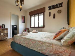 a bedroom with a large bed with pillows on it at Venezia-Mestre Train Station Relax Suites in Venice