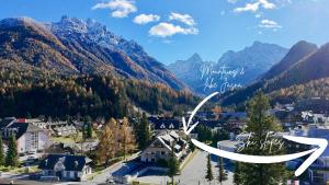 a view of a town in a valley with mountains at Vila Mojca SKI IN&OUT - Apartmaji Lena in Kranjska Gora