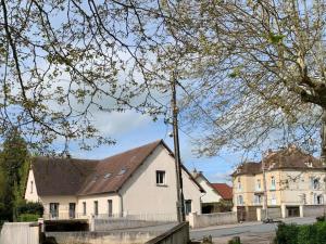 a white house with a fence in front of it at L'Arbre de Vie in Montmarault +2 photos