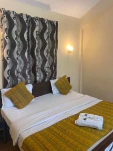 Ένα ή περισσότερα κρεβάτια σε δωμάτιο στο Hotel The Baga Palms