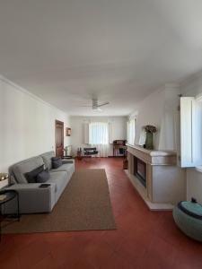 a living room with a couch and a fireplace at Casa de S Bento in Santarém +28 photos
