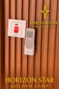 a calculator on a wooden table with a houston star golden camp at Horizon Star Golden Camp in Wadi Rum