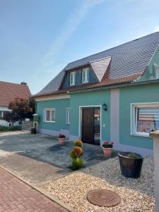 a house with a driveway in front of it at Pension Sommerfrische in Nebra