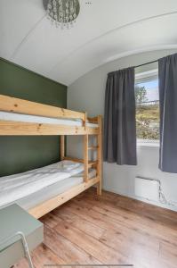 a room with bunk beds and a window at Yttersia Base in Senja