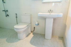 a bathroom with a toilet and a sink at Magnoon in Hikkaduwa