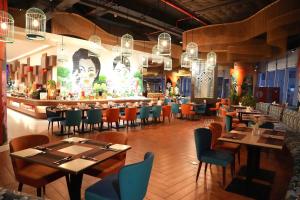 a restaurant with tables and chairs and a bar at Panorama Sky Beach Recidences in Nha Trang