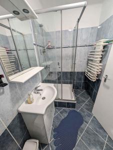 a bathroom with a sink and a shower and a toilet at Holiday home in Zamardi - Balaton 54796 in Zamárdi +22 photos