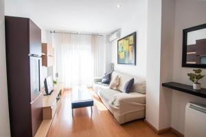 a living room with a couch and a table at Armilla Apartament in Armilla