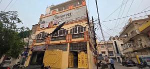 a building with a sign on the side of it at Hotel O Banaras Guest House in Banāras Cantonment