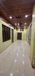 a large room with a large white floor and a ceiling at Hotel O Banaras Guest House in Banāras Cantonment +4 photos