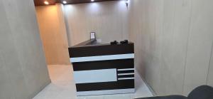 a lobby with a black and white reception desk at Hotel O Banaras Guest House in Banāras Cantonment