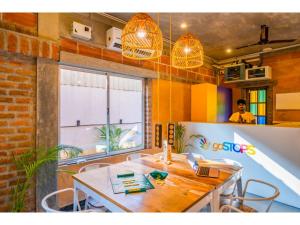 a dining room with a table and chairs and a window at goSTOPS Pondicherry Near Auroville in Auroville