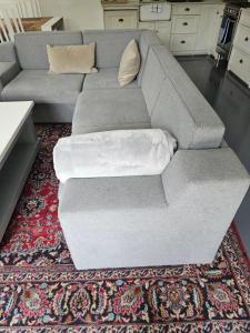 a gray couch sitting on a rug in a living room at PinotageLuxuryCollection 14 Bastmolen in Stellenbosch