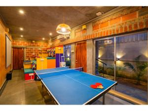 a blue ping pong table in a room at goSTOPS Pondicherry Near Auroville in Auroville