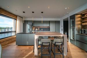 a kitchen with a table and some chairs at Le Chalet Royal by Aavalevi in Levi +68 photos