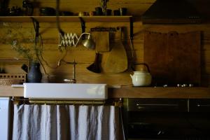 a kitchen with a sink and a counter with utensils at Kukučio ausy in Trasninkas