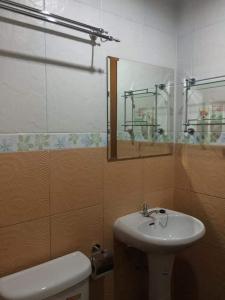 a bathroom with a sink and a toilet and a mirror at lanta our home apartment in Ko Lanta Yai