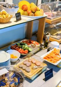a buffet filled with different types of food on display at Hotel Herian in Parsdorf +27 photos