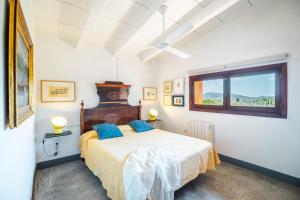 a bedroom with a bed and a window at Can Pessal in Es Carritxo +41 photos