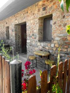a stone building with a table and two stools at Archontiko Kantilis in Díon