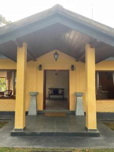 a large building with a large doorway with columns at Sarangu VIlla in Akuressa +3 photos