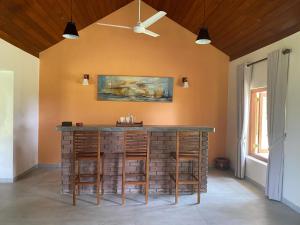 a bar in a room with chairs and a ceiling at Sarangu VIlla in Akuressa