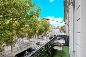 a balcony with a bench on a city street at Pyramide in Mulhouse