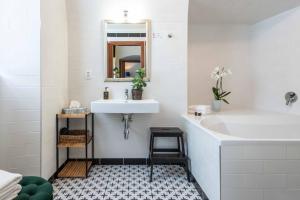 a white bathroom with a sink and a mirror at Zámecký hotel & Wellness in Poděbrady