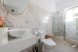 a bathroom with a sink toilet and a mirror at Quinta das Virtudes in Funchal +57 photos