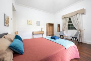 a bedroom with a large bed and a window at Quinta das Virtudes in Funchal