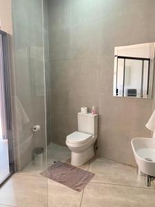 a bathroom with a toilet and a shower and a sink at 63 Lodging Villa in Rustenburg +15 photos
