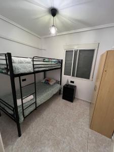 a bedroom with two bunk beds and a ceiling fan at Ground floor apartment with terrace and pool in La Mata +42 photos