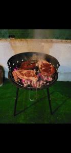 a dog is sitting on a grill with a pizza at Ground floor apartment with terrace and pool in La Mata