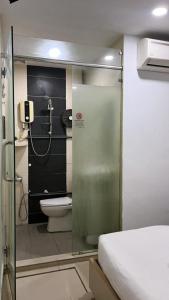 a small bathroom with a shower and a toilet at Pillows Plus City Top in Cheras
