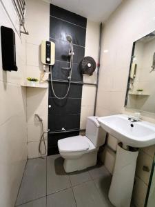 a bathroom with a shower and a toilet and a sink at Pillows Plus City Top in Cheras