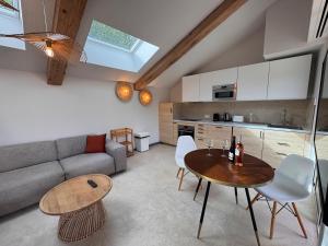 a living room with a couch and a table at La Master Grange De Queyran in La Palud sur Verdon