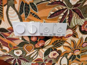 a white object on top of a bed with flowers at La Master Grange De Queyran in La Palud sur Verdon