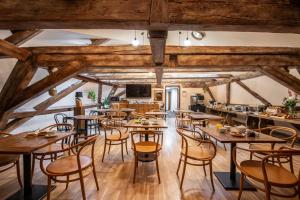 a dining room with wooden tables and chairs at Zámecký hotel & Wellness in Poděbrady