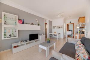 a living room with a couch and a tv at El Gin in Playa Blanca